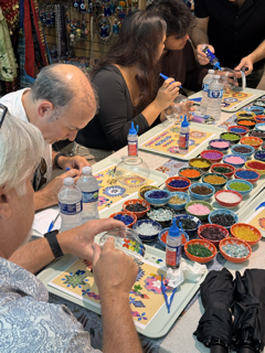 Students creating custom mosaic lamps in beginner art class
